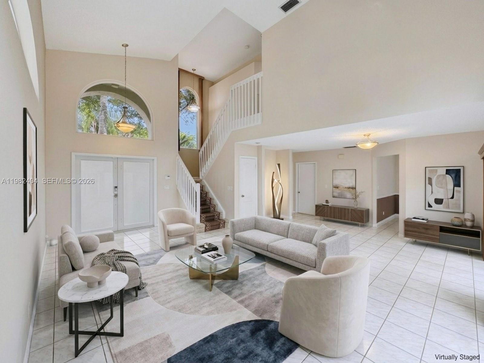 2640 Rampart Way North Cooper City, FL 33026 - Photo 6 of 58 a living room with furniture and a clock