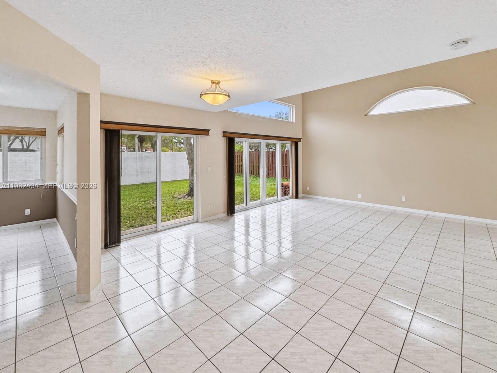 2640 Rampart Way North Cooper City, FL 33026 - Photo 9 of 58 a view of an empty room with window and a kitchen