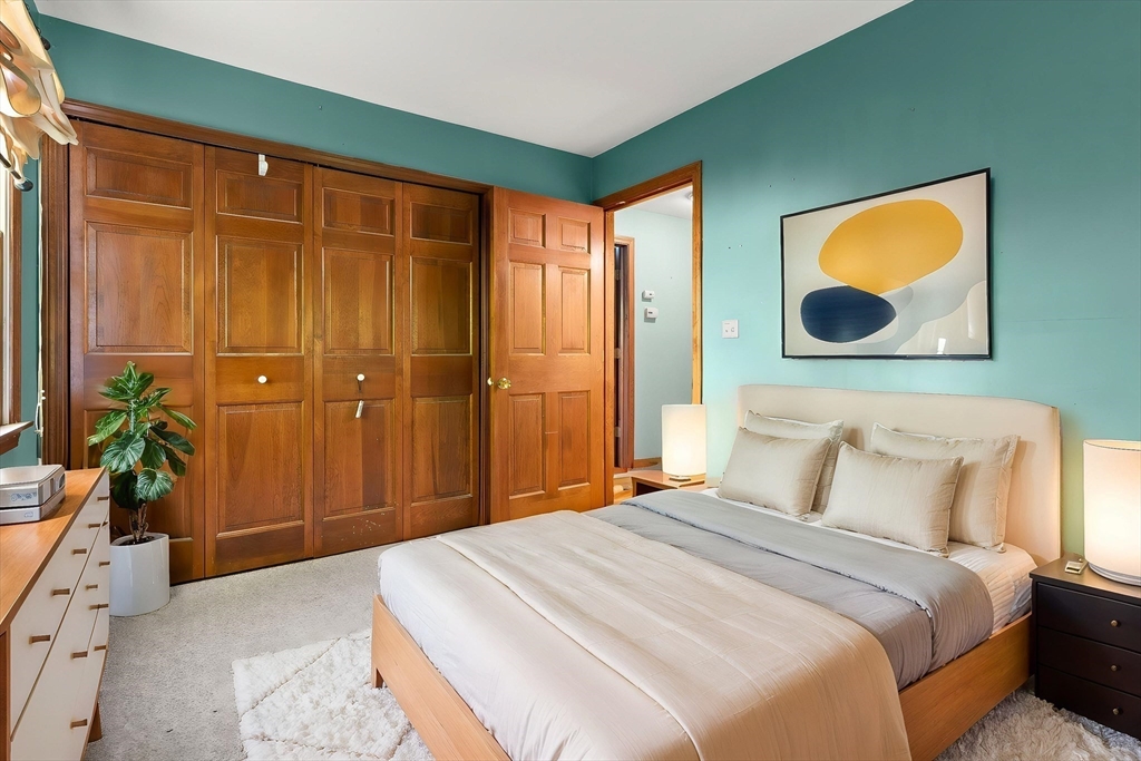 31 Kimball Road Amesbury, MA 01913 - Photo 22 of 40 a bedroom with a bed a potted plant with the wooden floor