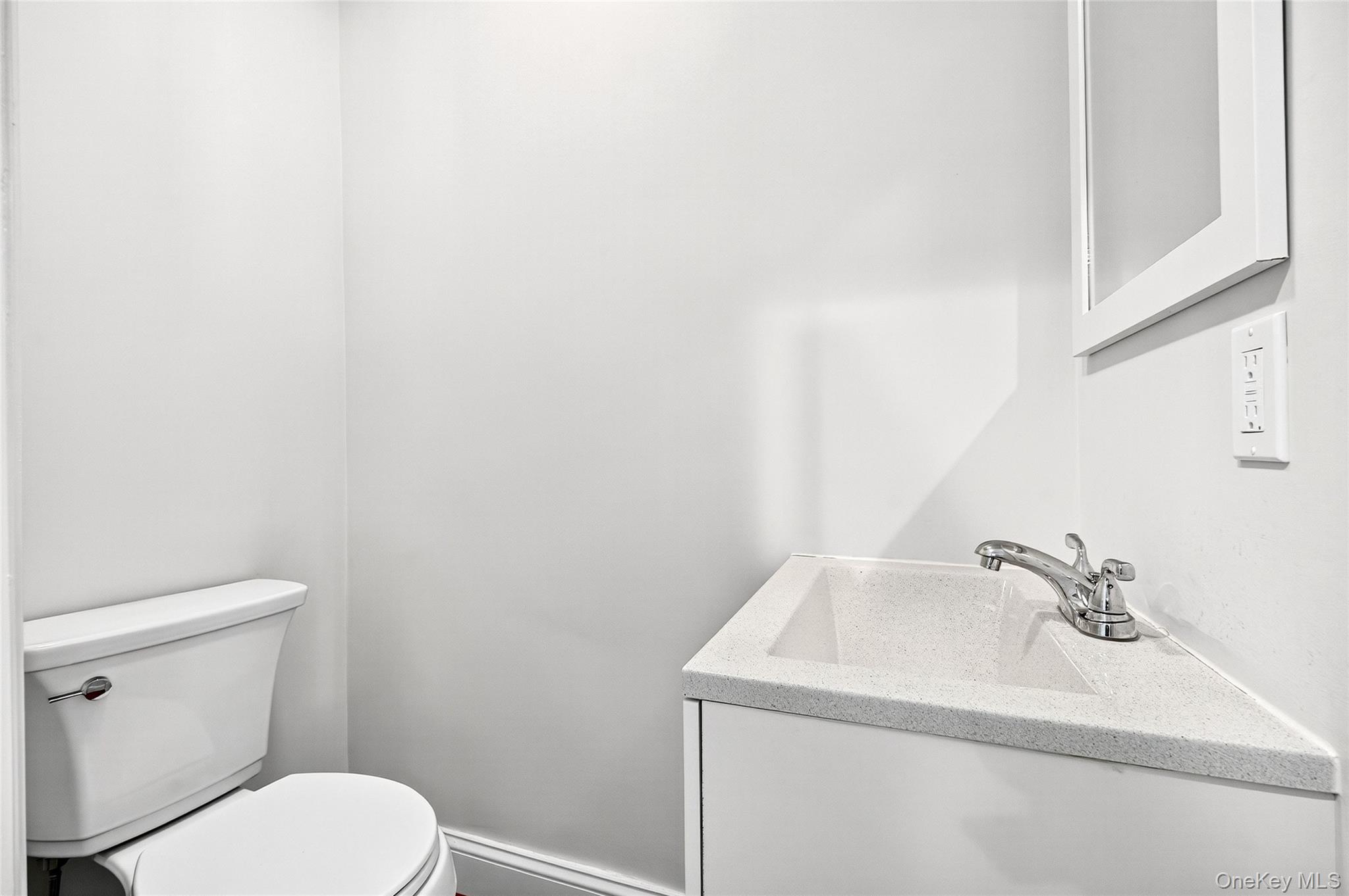 24 Wappanocca Avenue, Unit I Rye, NY 10580 - Photo 14 of 26 a bathroom with a sink a toilet and mirror