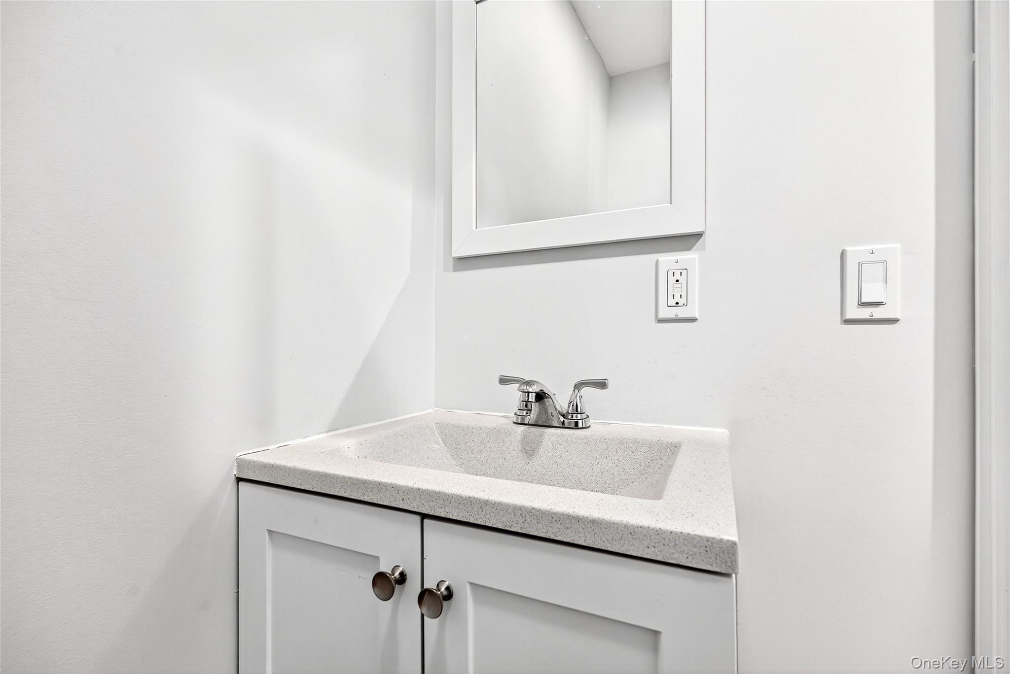 24 Wappanocca Avenue, Unit I Rye, NY 10580 - Photo 15 of 26 a bathroom with a sink and a mirror