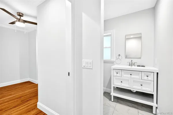a bathroom with a sink vanity and a mirror