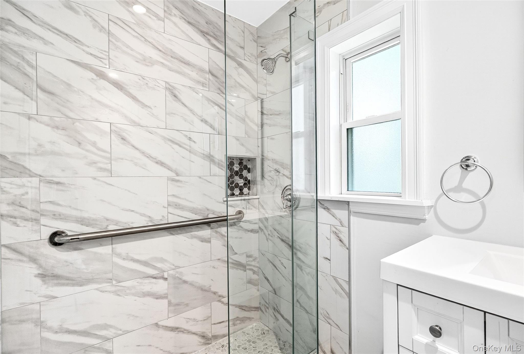 24 Wappanocca Avenue, Unit I Rye, NY 10580 - Photo 22 of 26 a bathroom with a sink and mirror