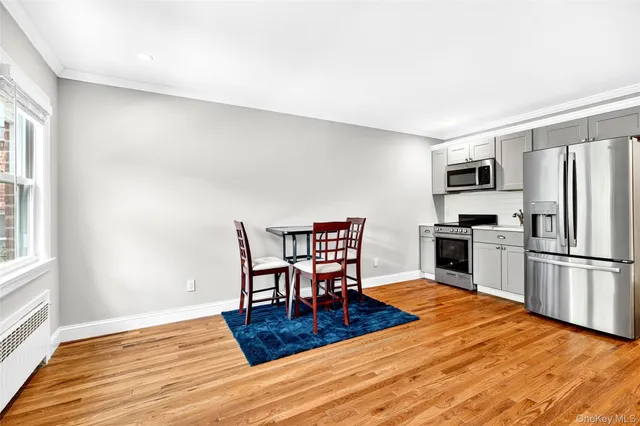 a kitchen with granite countertop a refrigerator stove top oven and stainless steel appliances