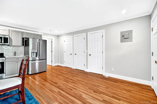 a view of kitchen with wooden floor and electronic appliances