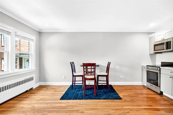 a dining room with furniture a rug and wooden floor