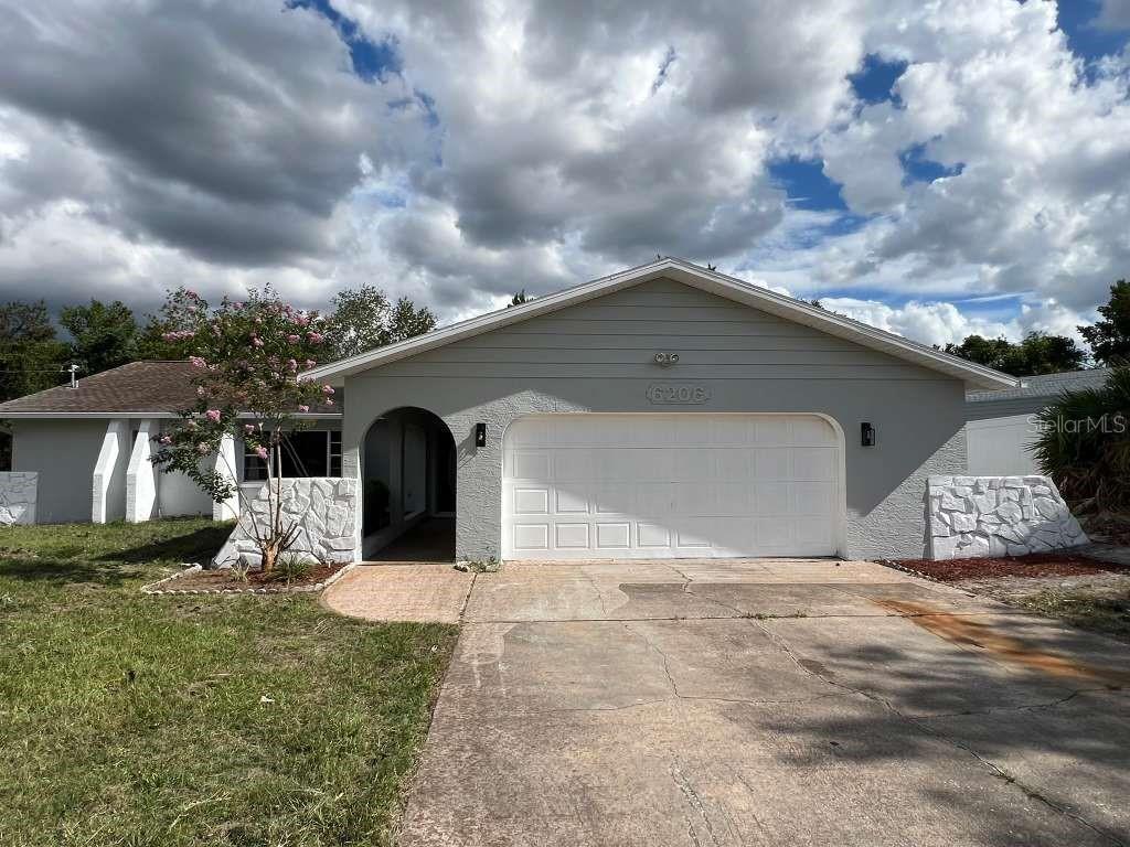 6206 Dorset Road Spring Hill, FL 34608 - Photo 1 of 9 a front view of a house with a yard