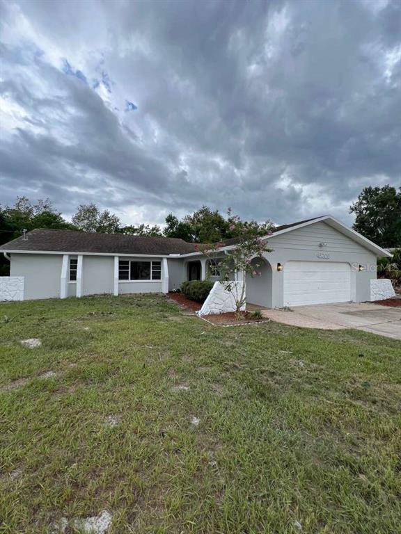 6206 Dorset Road Spring Hill, FL 34608 - Photo 2 of 9 a front view of house with yard and trees