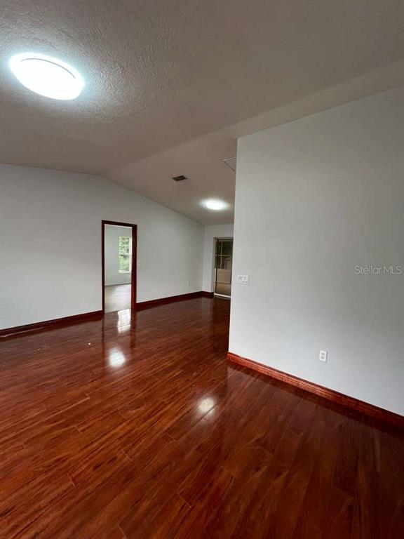 6206 Dorset Road Spring Hill, FL 34608 - Photo 5 of 9 a view of an empty room with wooden floor