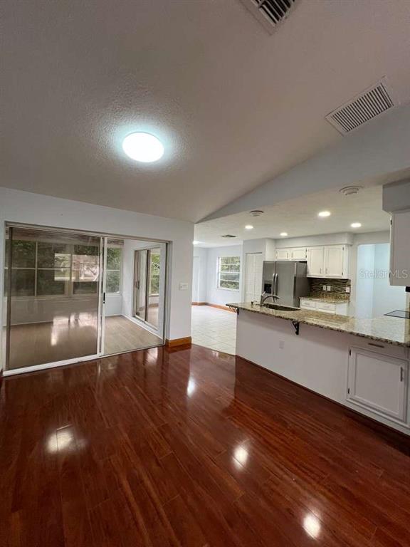 6206 Dorset Road Spring Hill, FL 34608 - Photo 6 of 9 a view of kitchen with wooden floor and windows