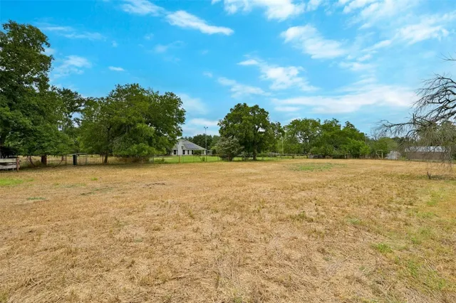 a view of yard with swimming pool and green space