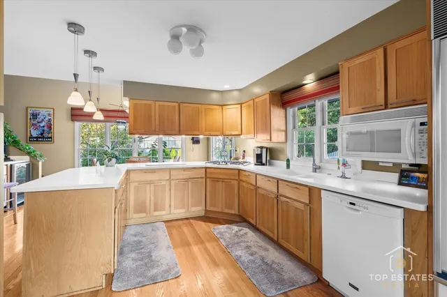 a kitchen with stainless steel appliances granite countertop a sink and cabinets