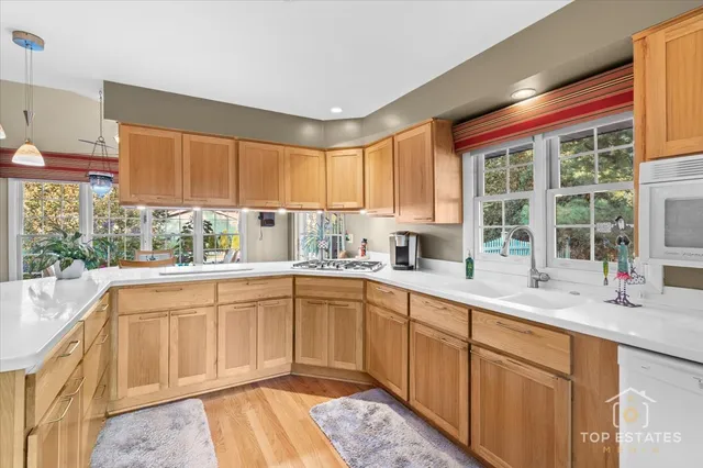 a kitchen with a sink window and cabinets