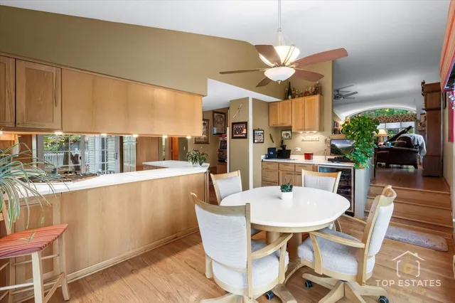a dining room with large window a table and chairs