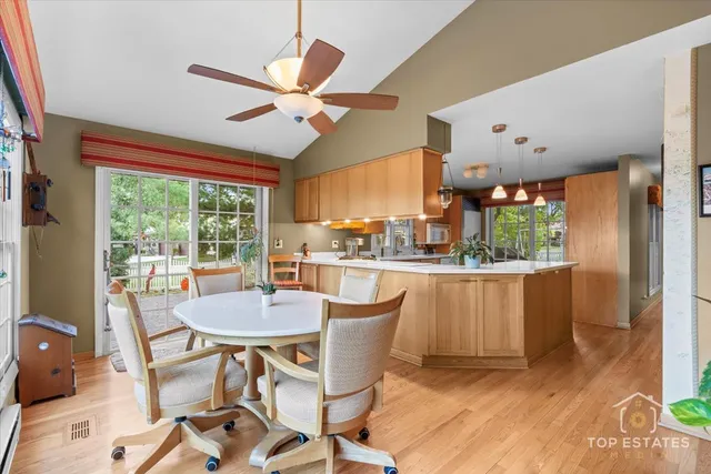 a dining room with furniture a chandelier and wooden floor