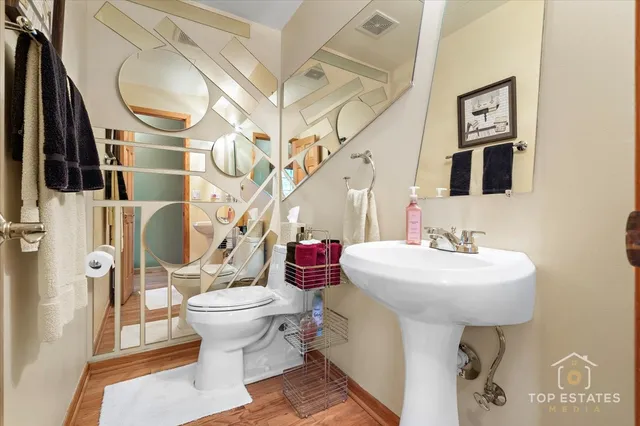 a bathroom with a sink toilet and a mirror