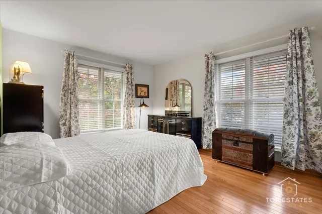 a bedroom with a bed a mirror and a window