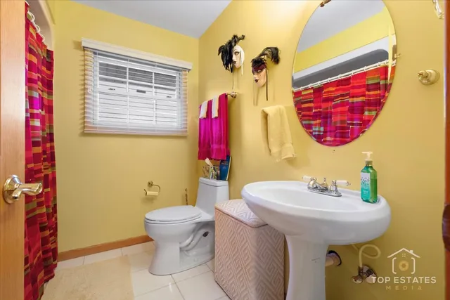 a bathroom with a sink toilet and a mirror