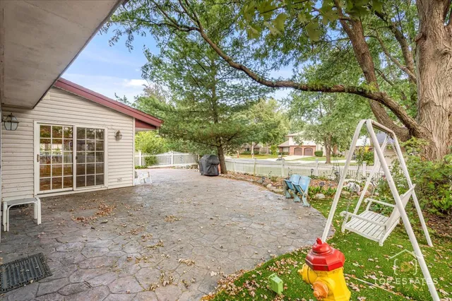 a view of a backyard with table and chairs and potted plants