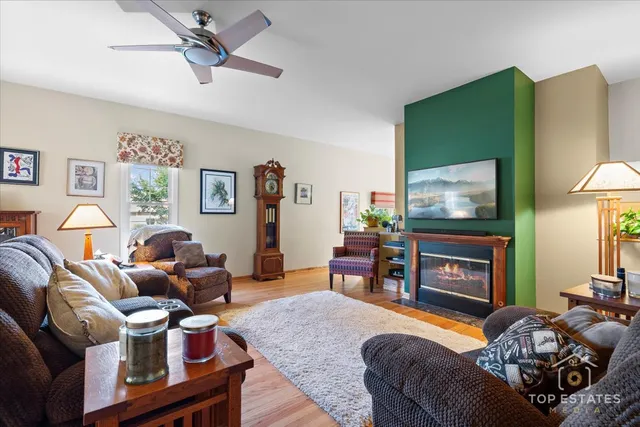 a living room with furniture a flat screen tv and a fireplace