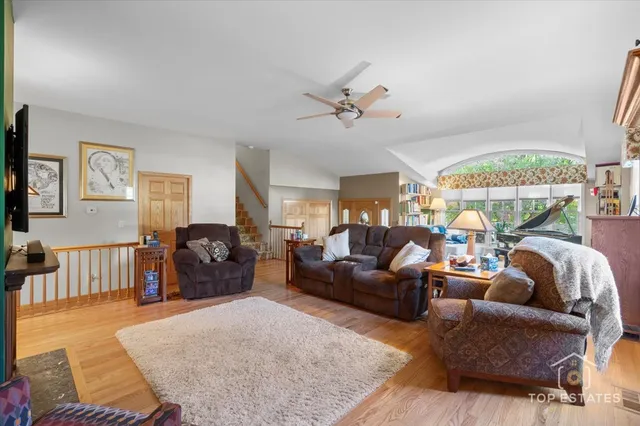 a living room with furniture a couch and a large window