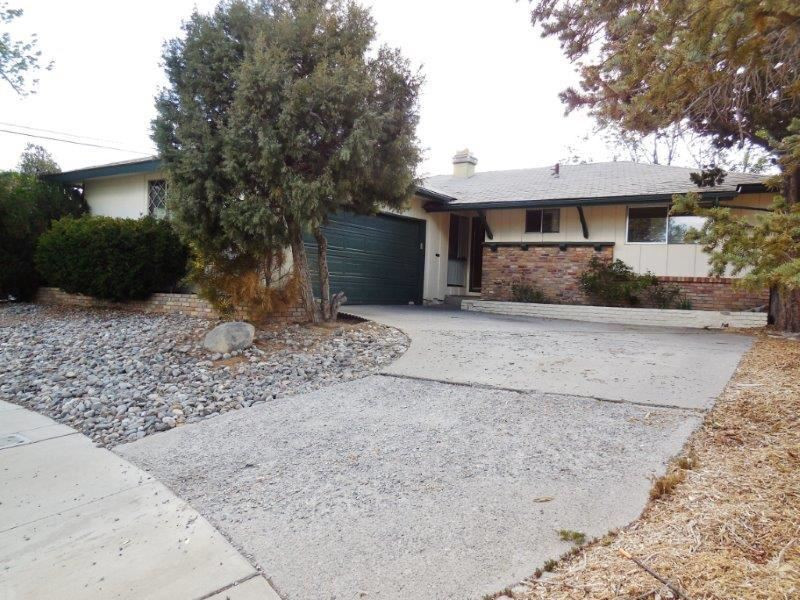 715 James Court Reno, NV 89503 - Photo 1 of 1 a front view of a house with a yard and a garage
