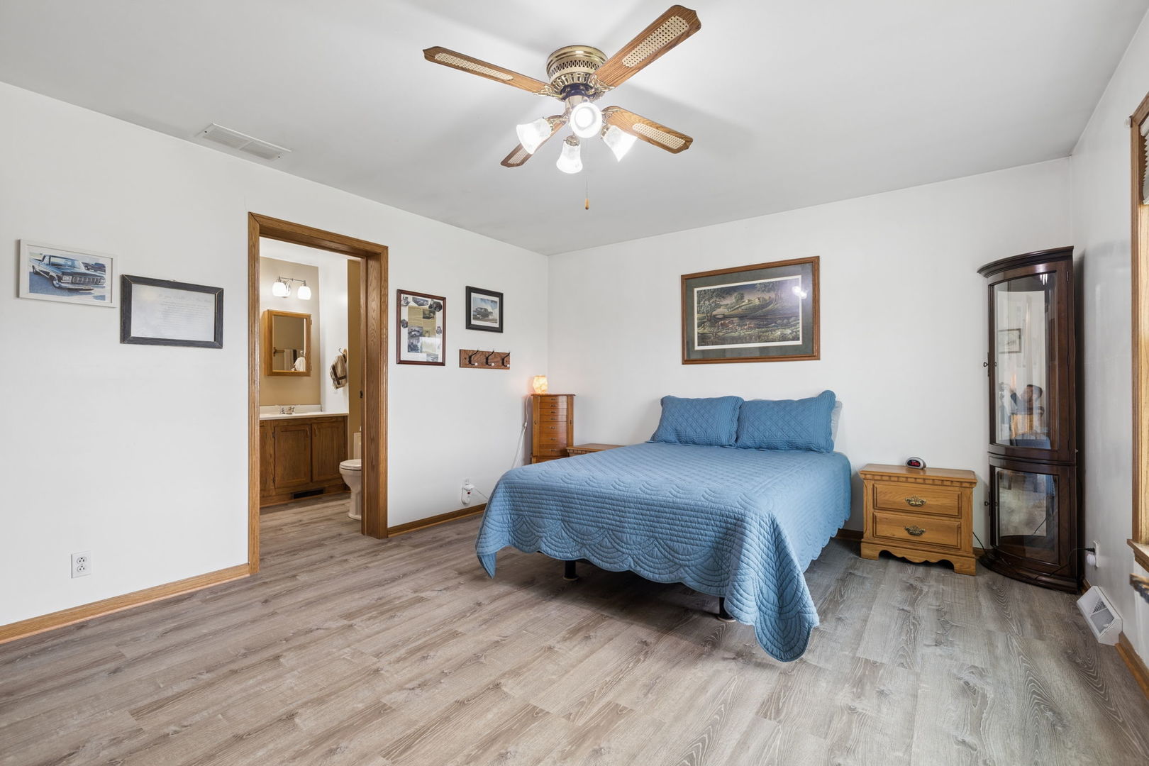 15334 West 3000N Road Essex, IL 60935 - Photo 14 of 42 a spacious bedroom with a bed and a chandelier