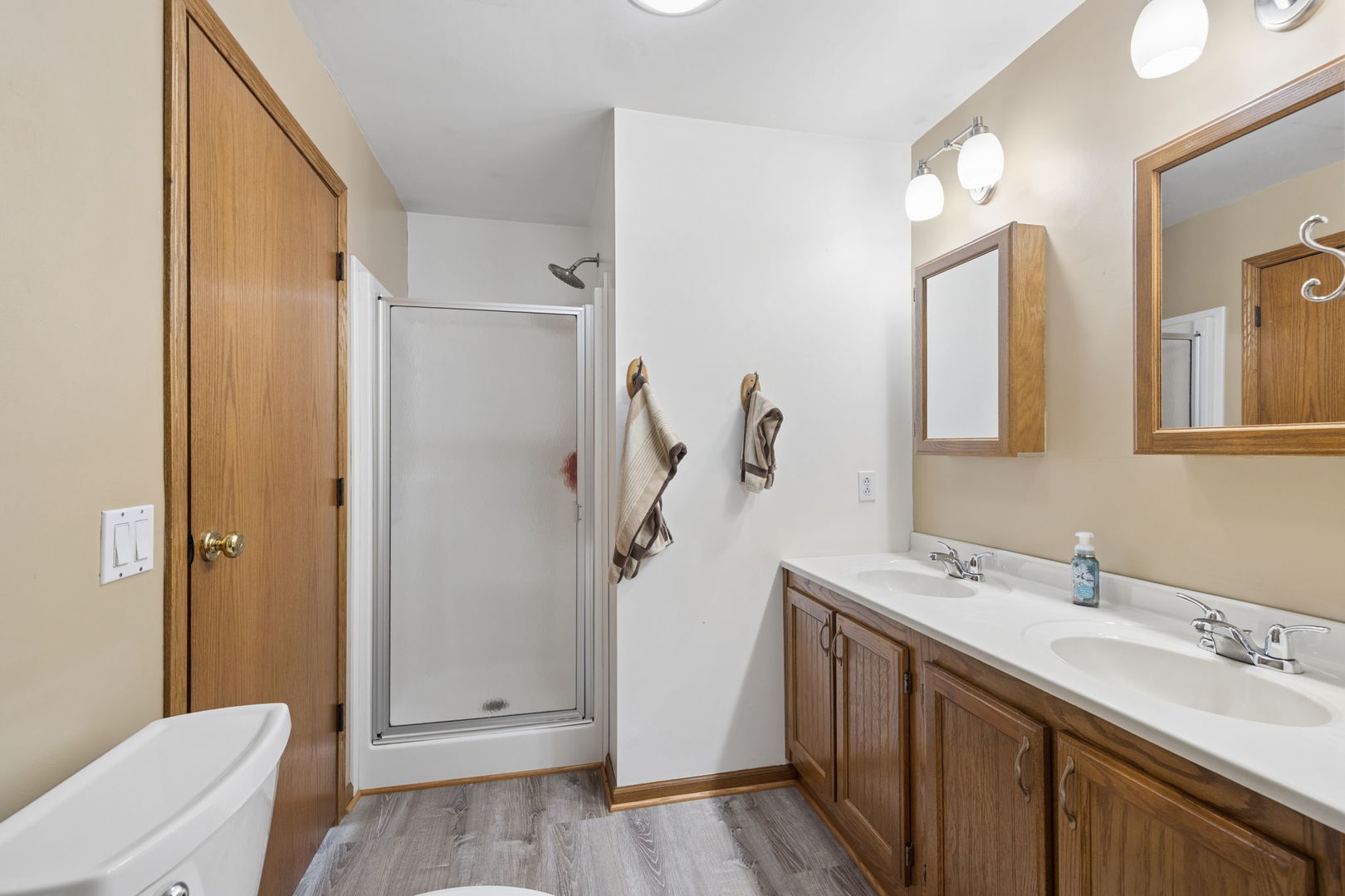 15334 West 3000N Road Essex, IL 60935 - Photo 16 of 42 a bathroom with a double vanity sink a toilet and a mirror