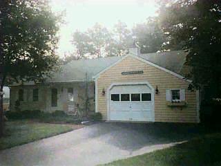 Undisclosed Address Centerville, MA 02632 - Photo 1 of 1 a front view of a house with a garden