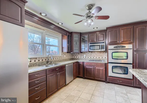 a kitchen with a stove sink and cabinets