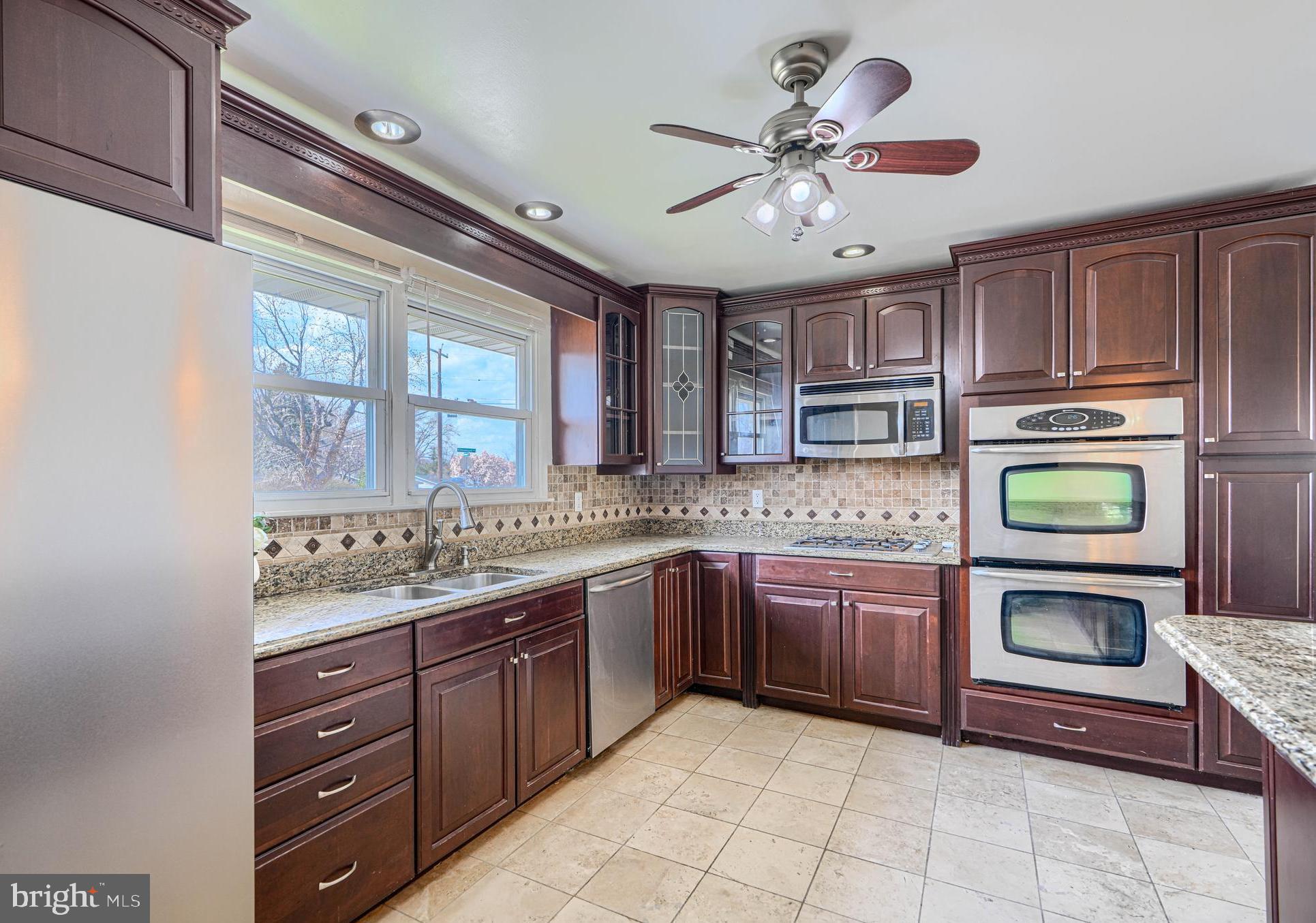 a kitchen with a stove sink and cabinets