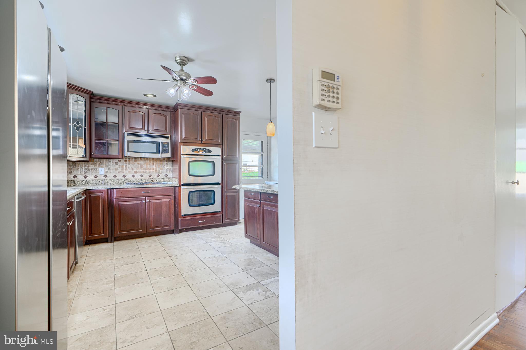1741 Ellinwood Road Rosedale, MD 21237 - Photo 12 of 43 a view of an empty room with window and cabinet