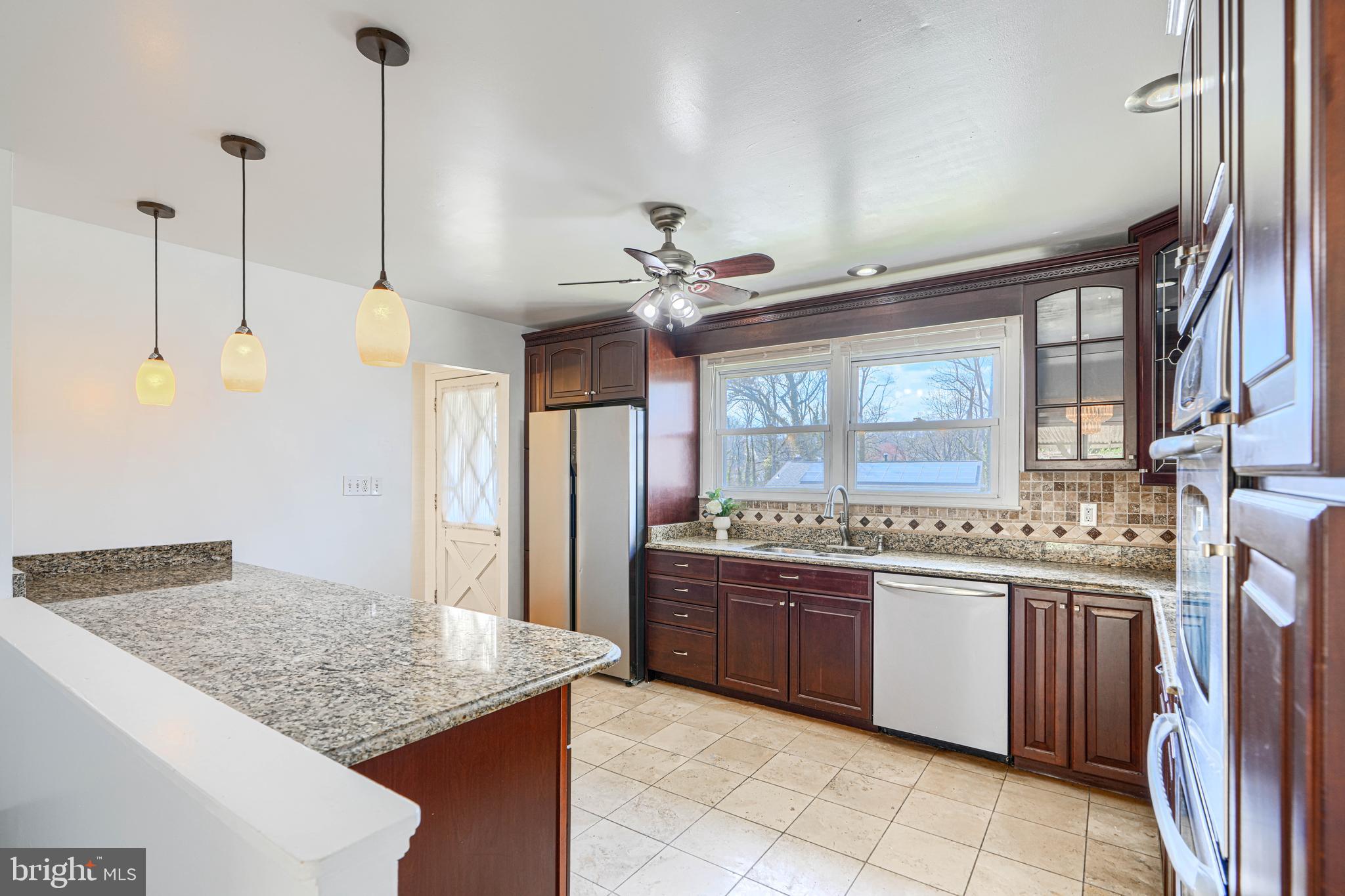 1741 Ellinwood Road Rosedale, MD 21237 - Photo 15 of 43 a kitchen with stainless steel appliances granite countertop a sink and a refrigerator