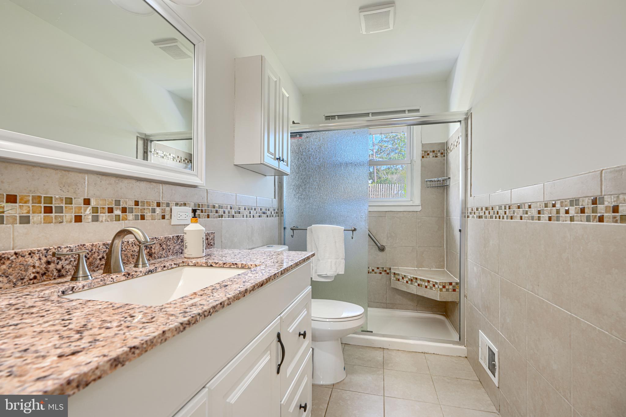1741 Ellinwood Road Rosedale, MD 21237 - Photo 17 of 43 a bathroom with a granite countertop sink mirror vanity and toilet