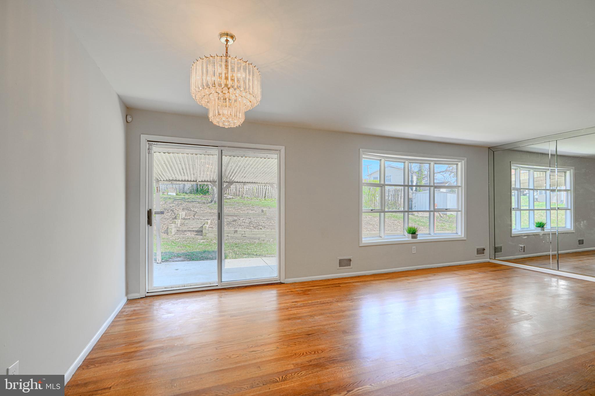 1741 Ellinwood Road Rosedale, MD 21237 - Photo 3 of 43 an empty room with wooden floor and windows
