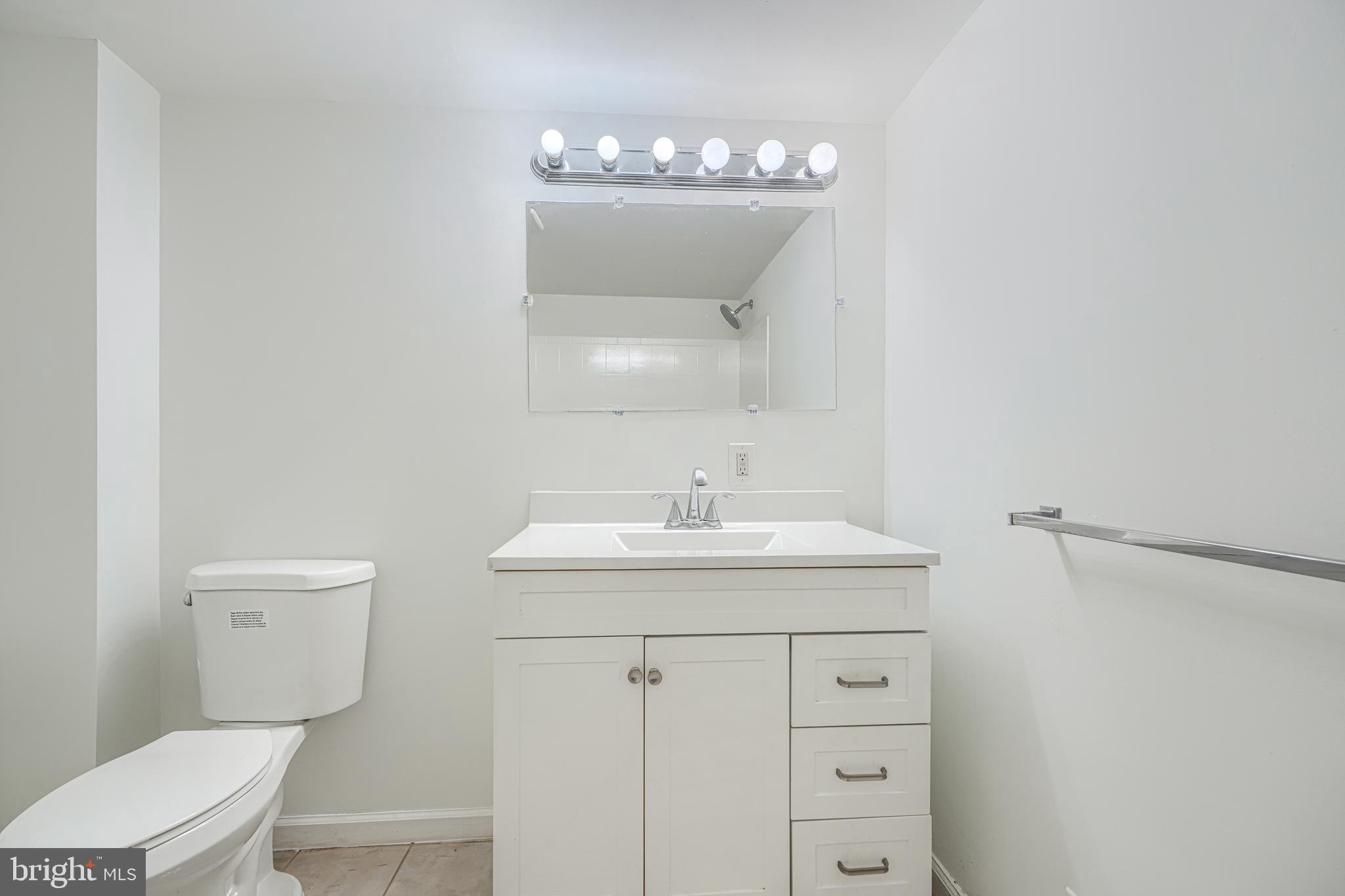 1741 Ellinwood Road Rosedale, MD 21237 - Photo 37 of 43 a bathroom with a toilet a sink and mirror