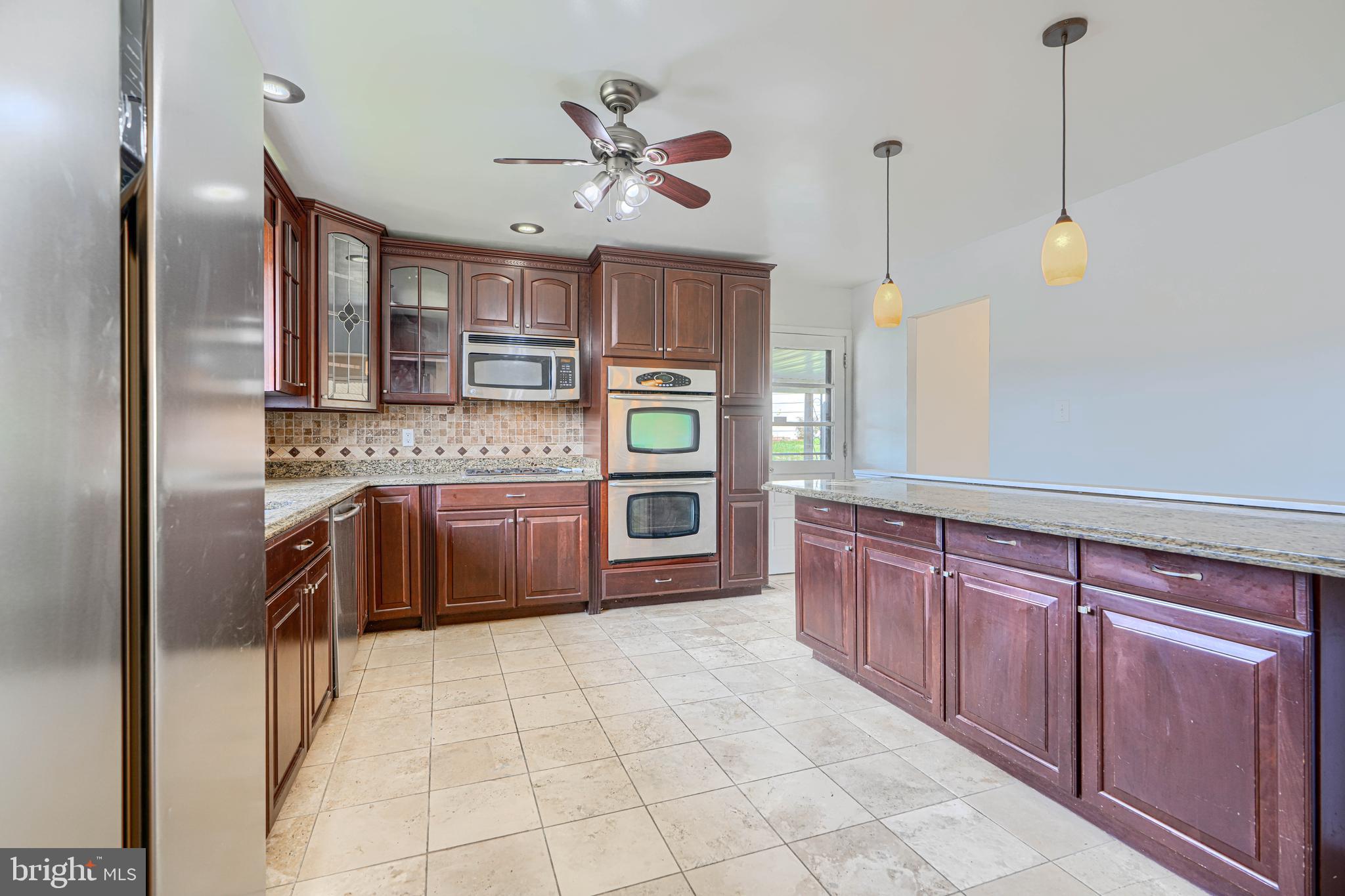 1741 Ellinwood Road Rosedale, MD 21237 - Photo 5 of 43 a kitchen with stainless steel appliances granite countertop a sink and cabinets
