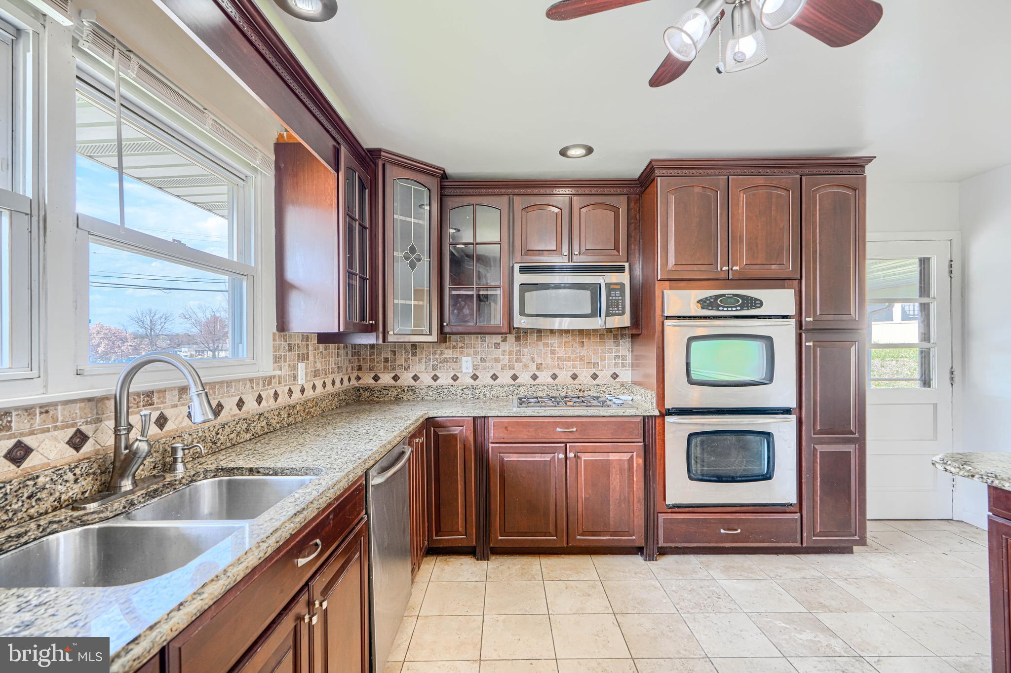 1741 Ellinwood Road Rosedale, MD 21237 - Photo 7 of 43 a kitchen with stainless steel appliances granite countertop a sink and cabinets