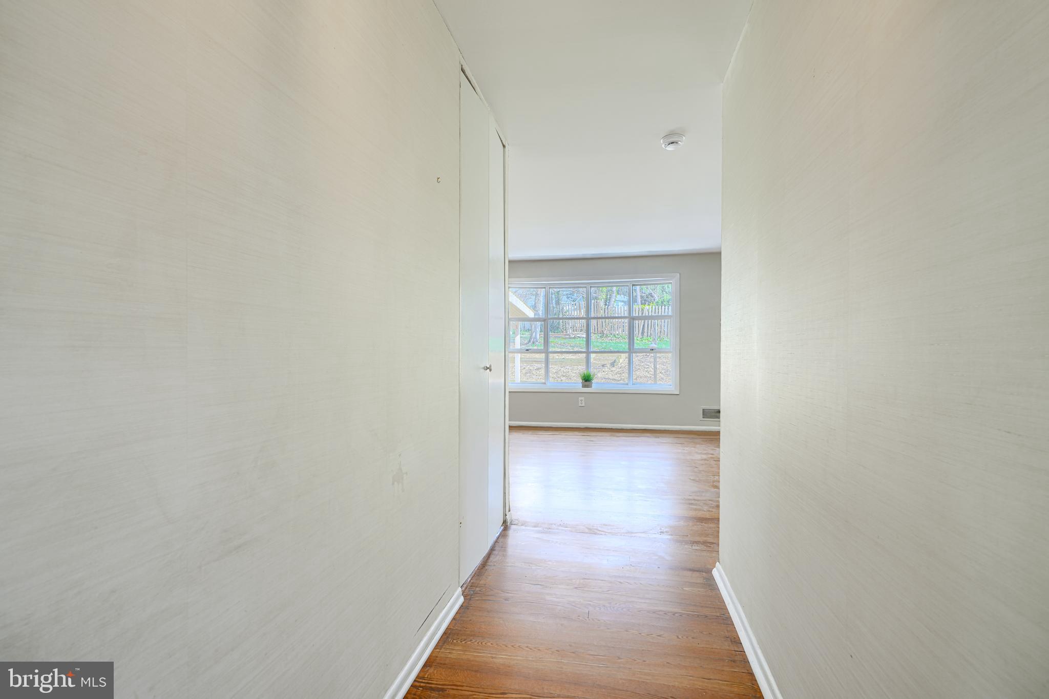 1741 Ellinwood Road Rosedale, MD 21237 - Photo 9 of 43 a view of a hallway with wooden floor and a bathroom