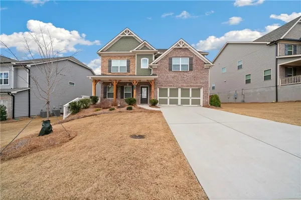 a front view of a house with a yard