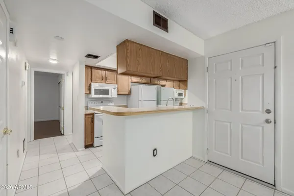 a kitchen with white cabinets and sink