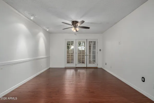 wooden floor in an empty room with a window