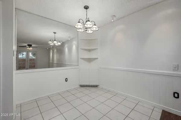 a view of a chandelier fan and entryway