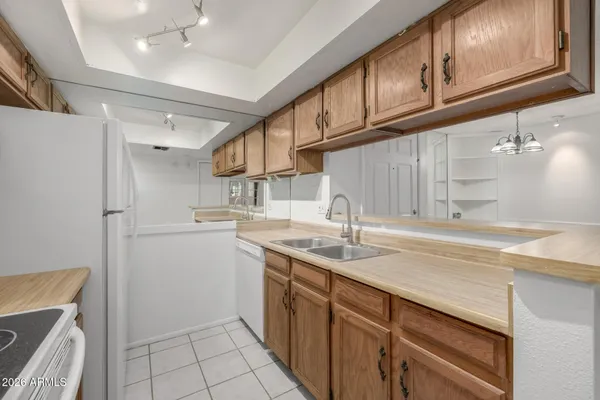 a kitchen with a sink cabinets and appliances