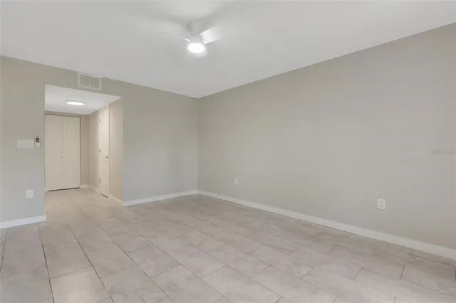 an empty room with windows and closet