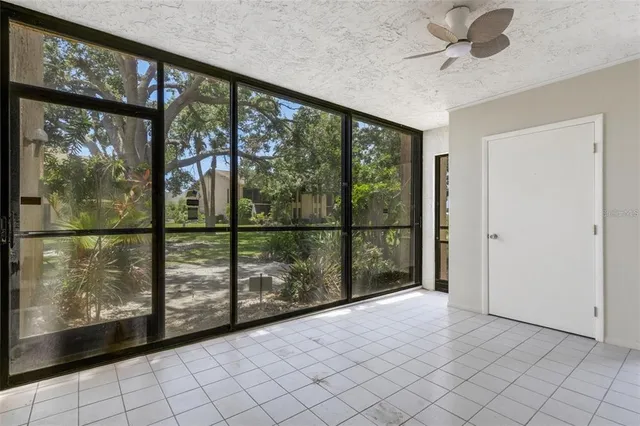 an empty room with windows and entrance
