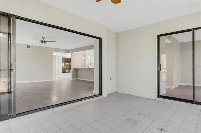 a view of an empty room with closet and chandelier fan