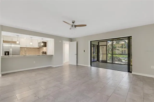 a view of an empty room with a kitchen