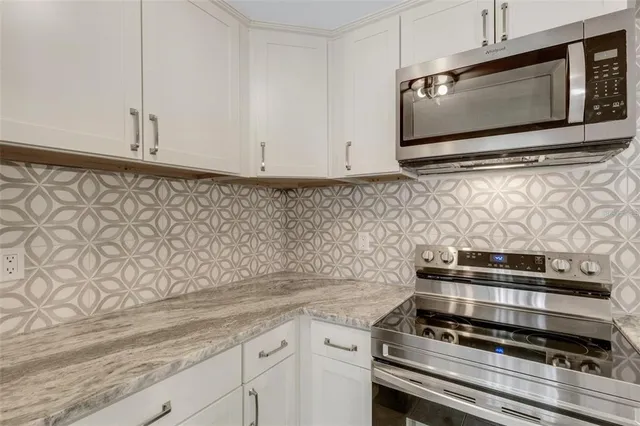 a stove top oven sitting inside of a kitchen