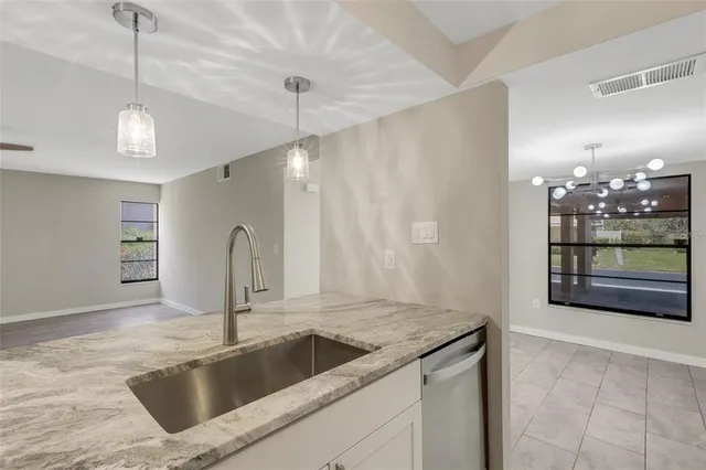 a kitchen with a sink and refrigerator